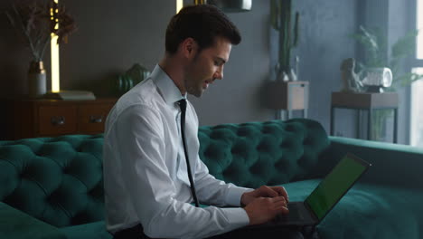 Businessman having video call on laptop. Entrepreneur waving hand at camera