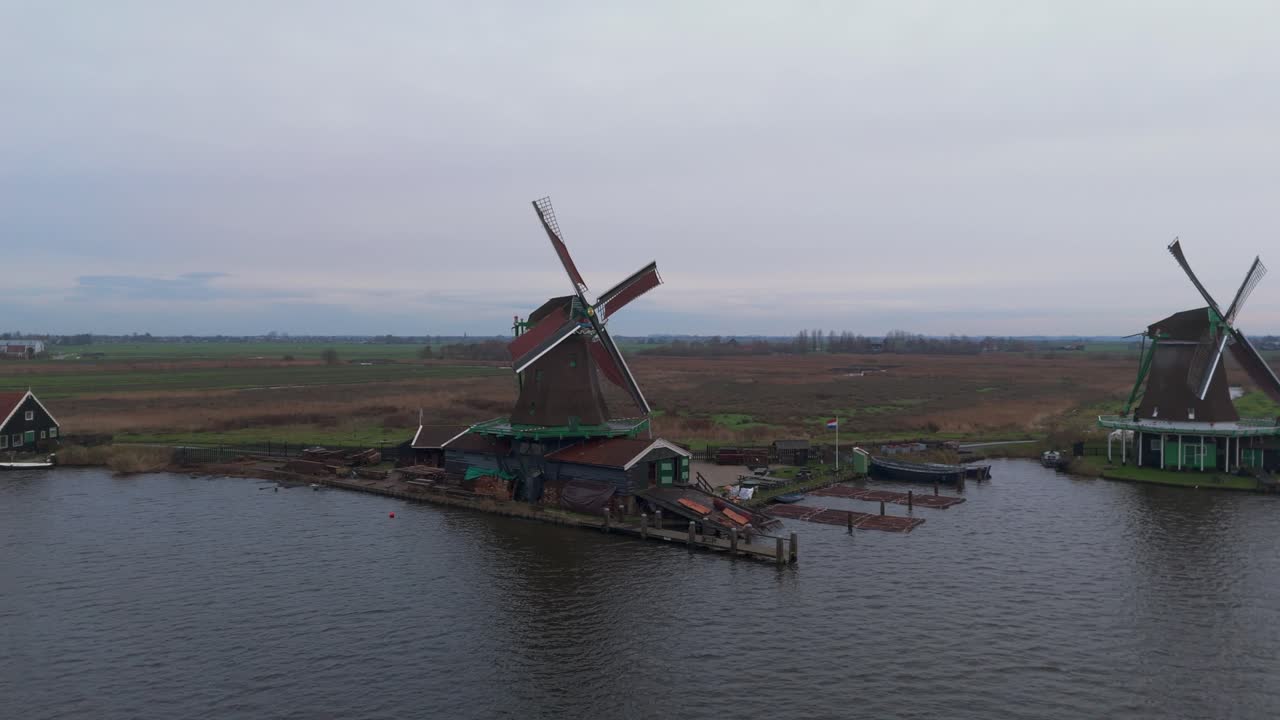 Dronevideo of the Windmills of zaanse schans (close to Amsterdam) in the early dawn lights.