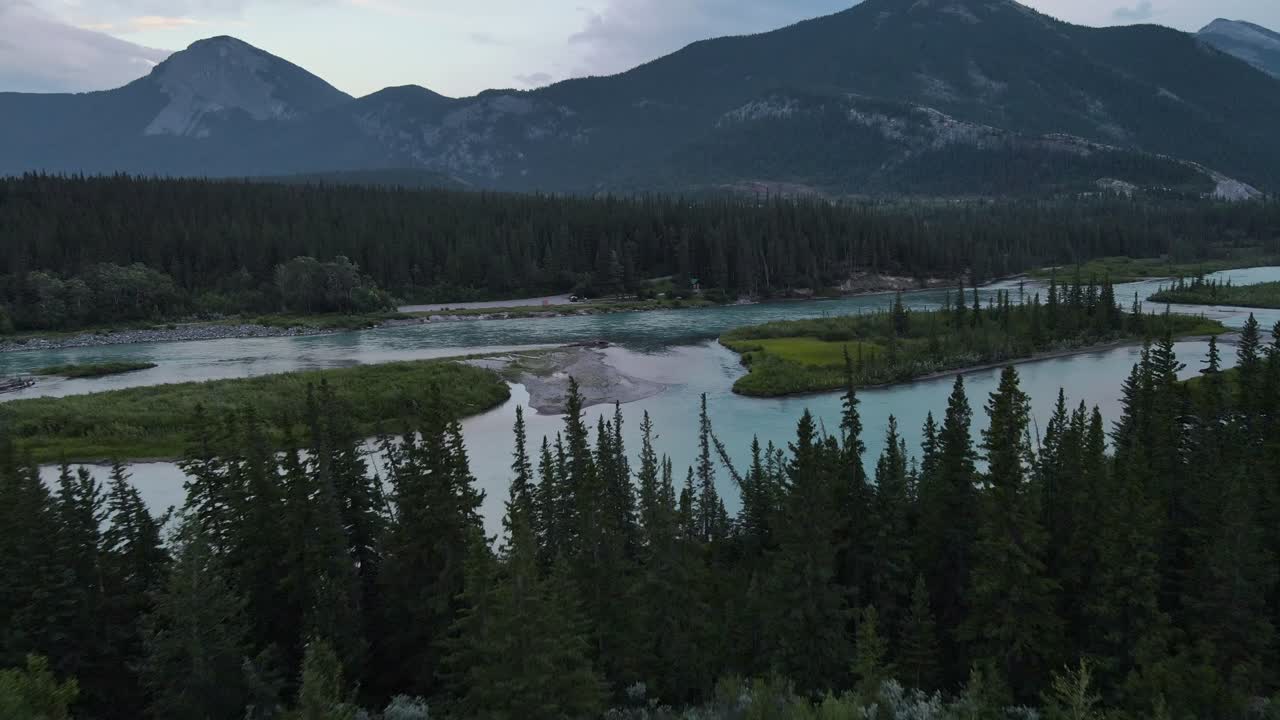impresionante río arco que fluye a través de las montañas rocosas en la hora azul en alberta, canadá