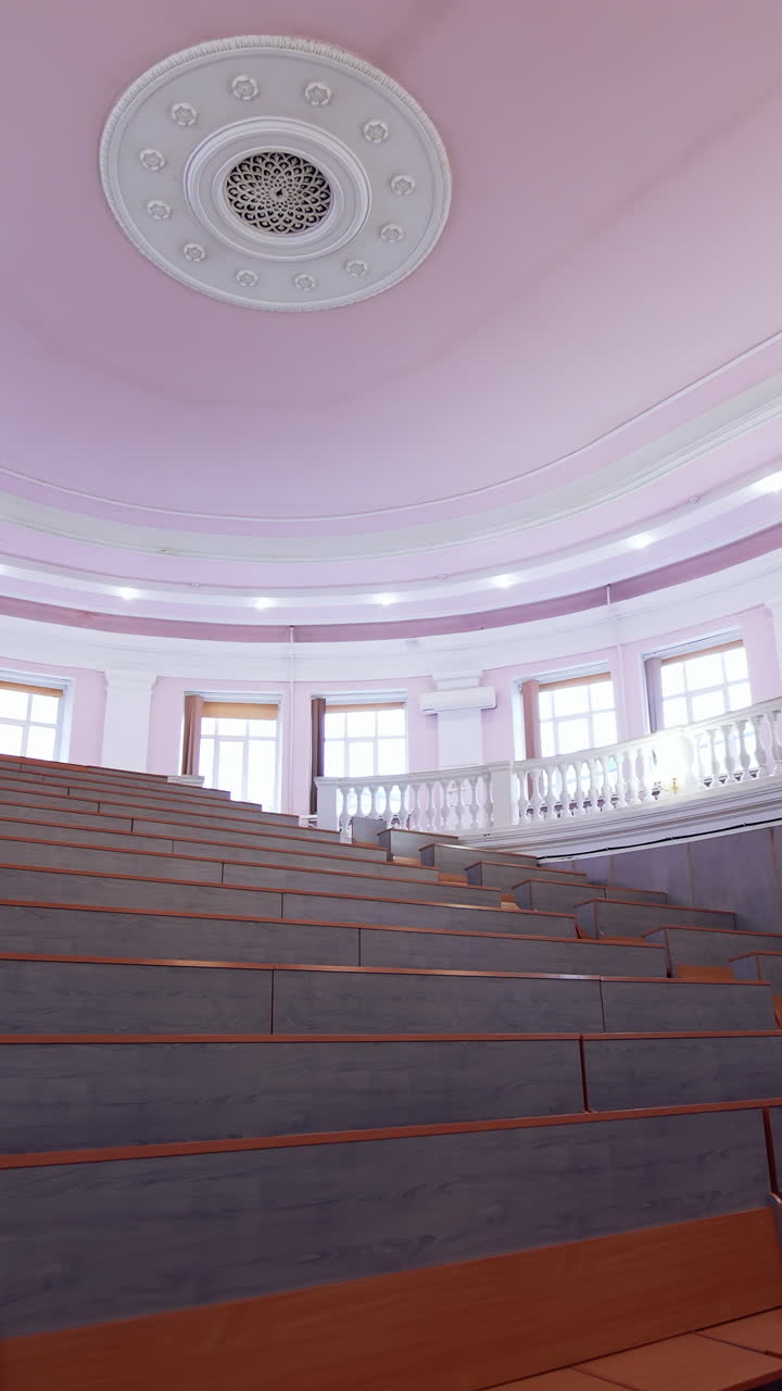 Interior of big auditorium. Inside university lecture hall with nobody inside. Vertical video