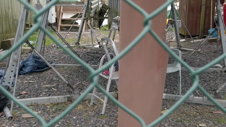 Garden chair under boat hull secure fenced shipyard repair project passing rudder dolly left