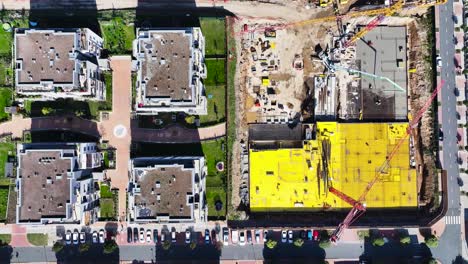 aerial view of a construction site and apartment buildings
