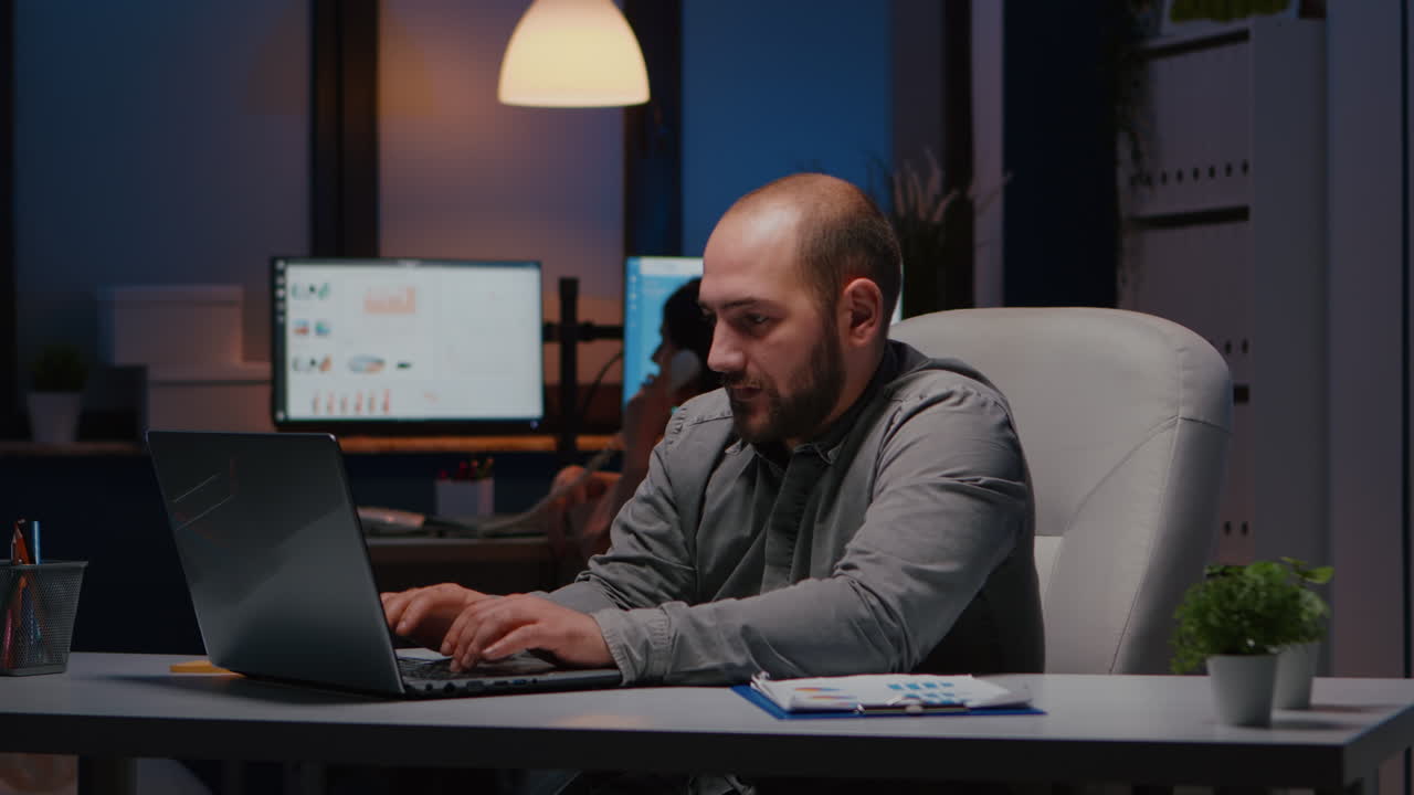 Happy successful businessman enjoying while looking at laptop computer