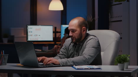happy successful businessman enjoying while looking at laptop computer