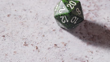 green 20-sided dice is rolled for table top roleplaying game, natural 20