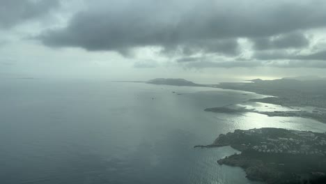 cockpit view approaching to ibiza’s airport before sunset and with a cloudy sky