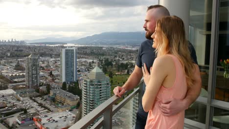 Couple-pointing-at-distance-in-balcony-4k