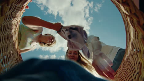 friends helping load laundry basket