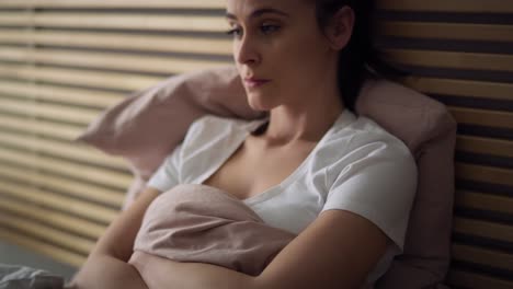 Tracking-video-of-depressed-woman-in-bed