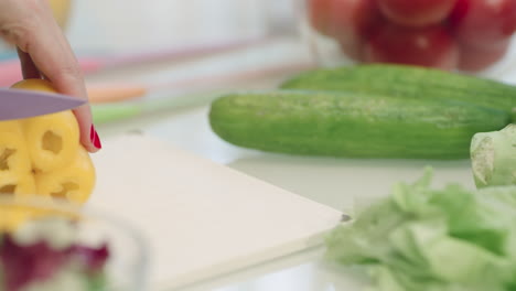 Closeup-woman-hands-cutting-pepper-in-slow-motion.