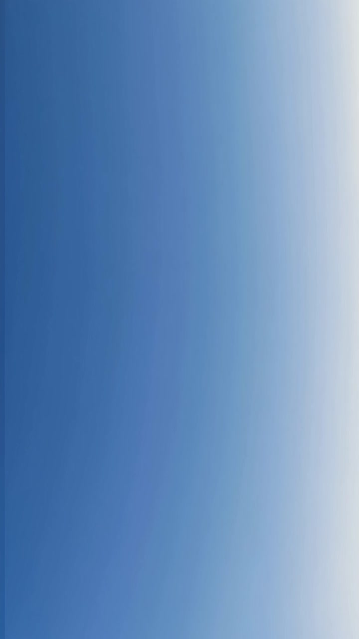 A vertical video of a serene blue gradient sky, captured from a low angle, creating a calming