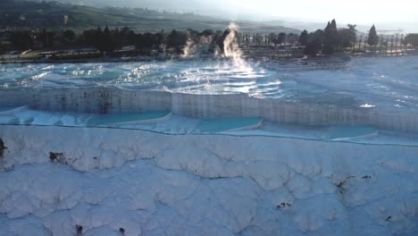 Steamy-blue-hot-springs,-mineral-waters,-forming-travertine-limestone-mineral-deposit-formations