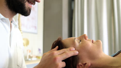 Physiotherapist-giving-head-massage-to-a-female-patient