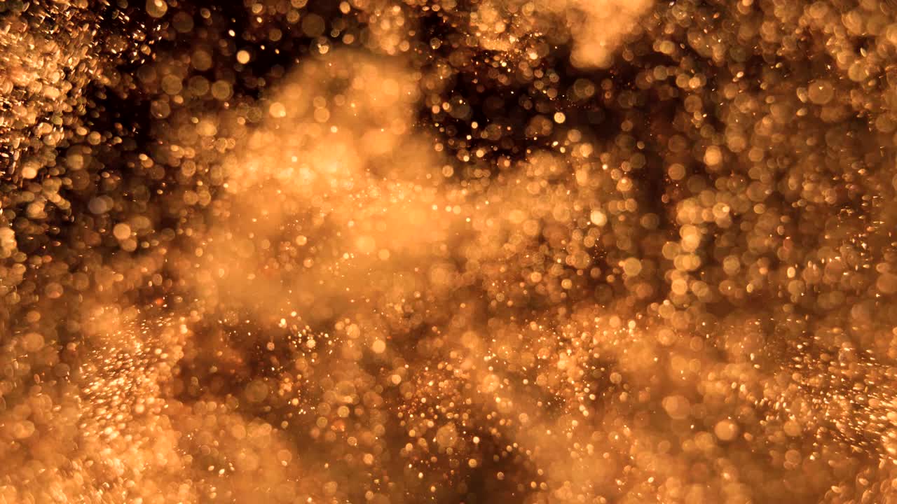 Elegant, detailed, and golden particles flow with shallow depth of field underwater