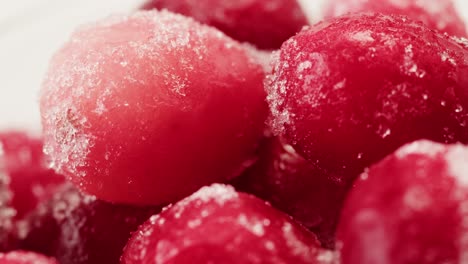 frozen cranberries in snow for tea, background close up of cranberry berries in winter park, ice fridge macro.