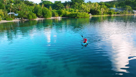 man kayaking on lake early morning on moso island in vanuatu
