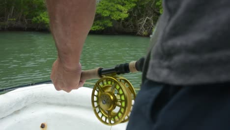 man fly fishing in a boat