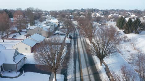 aerial establishing shot of homes in small town neighborhood development in usa