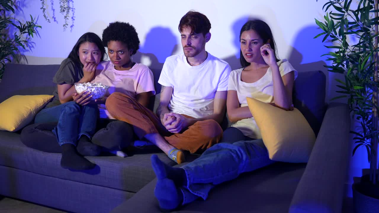Group of Friends Watching a Scary Movie on TV