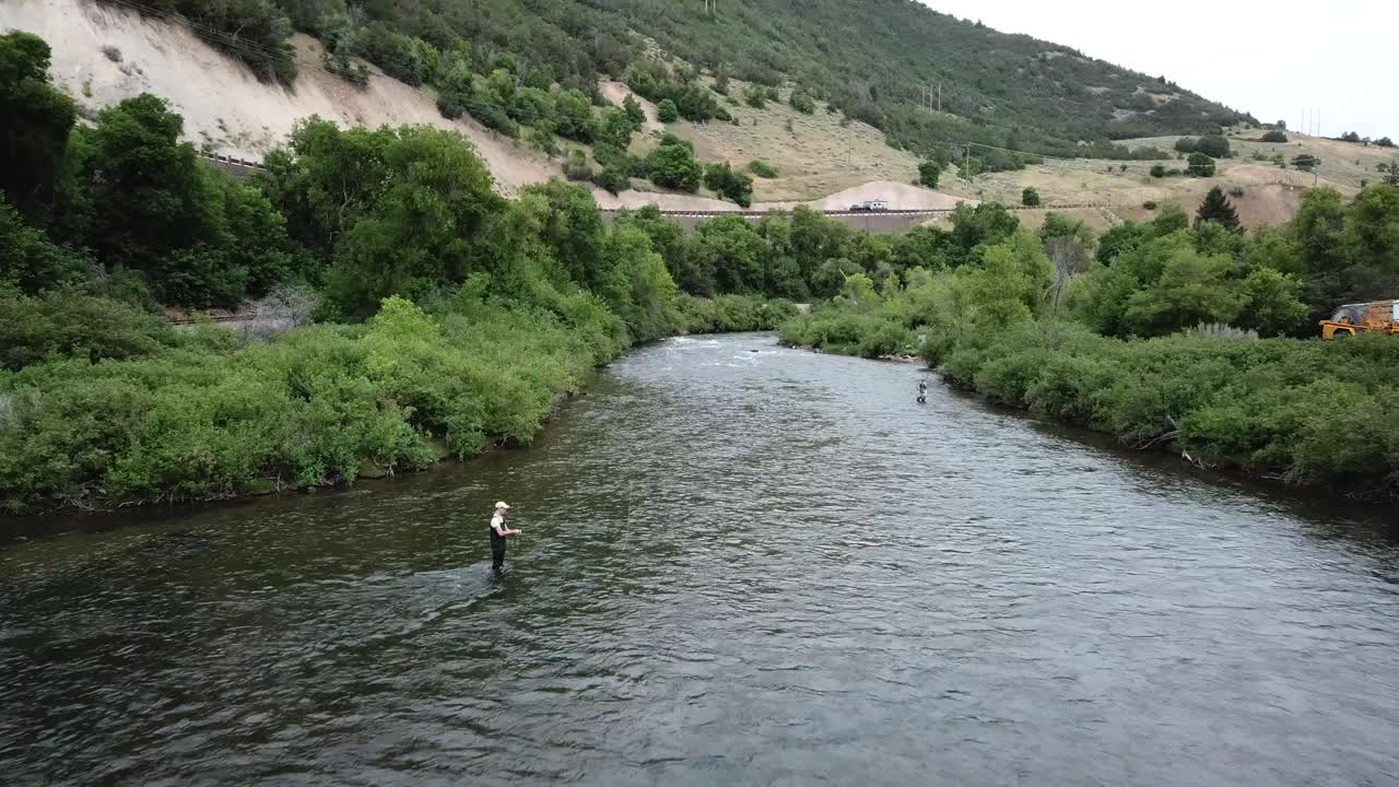 disparo de drones acercándose a un hombre pescando con mosca en el río provo en las montañas de utah