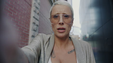 Woman Taking a Selfie in a City Alley
