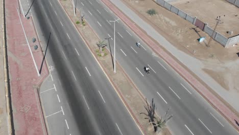 Aerial-shot-of-motorbike-and-car-running-in-the-highway-of-gawadar-balochistan