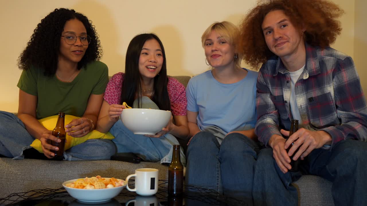 Friends enjoying a movie night with snacks and beer