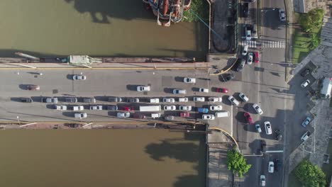 aerial top view over floating bridge traffic, ozama river in santo domingo city, dominican republic