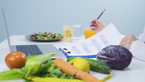 dietitian preparing diet plan on laptop.