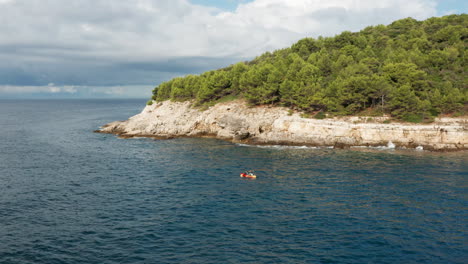 aerial view of people kayaking on the coast of pula in istria, croatia