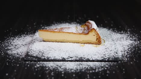 pouring honey on slice of cheesecake on stone plate close up shoot