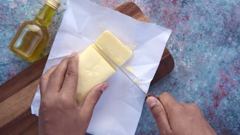 cutting butter on a wooden cutting board