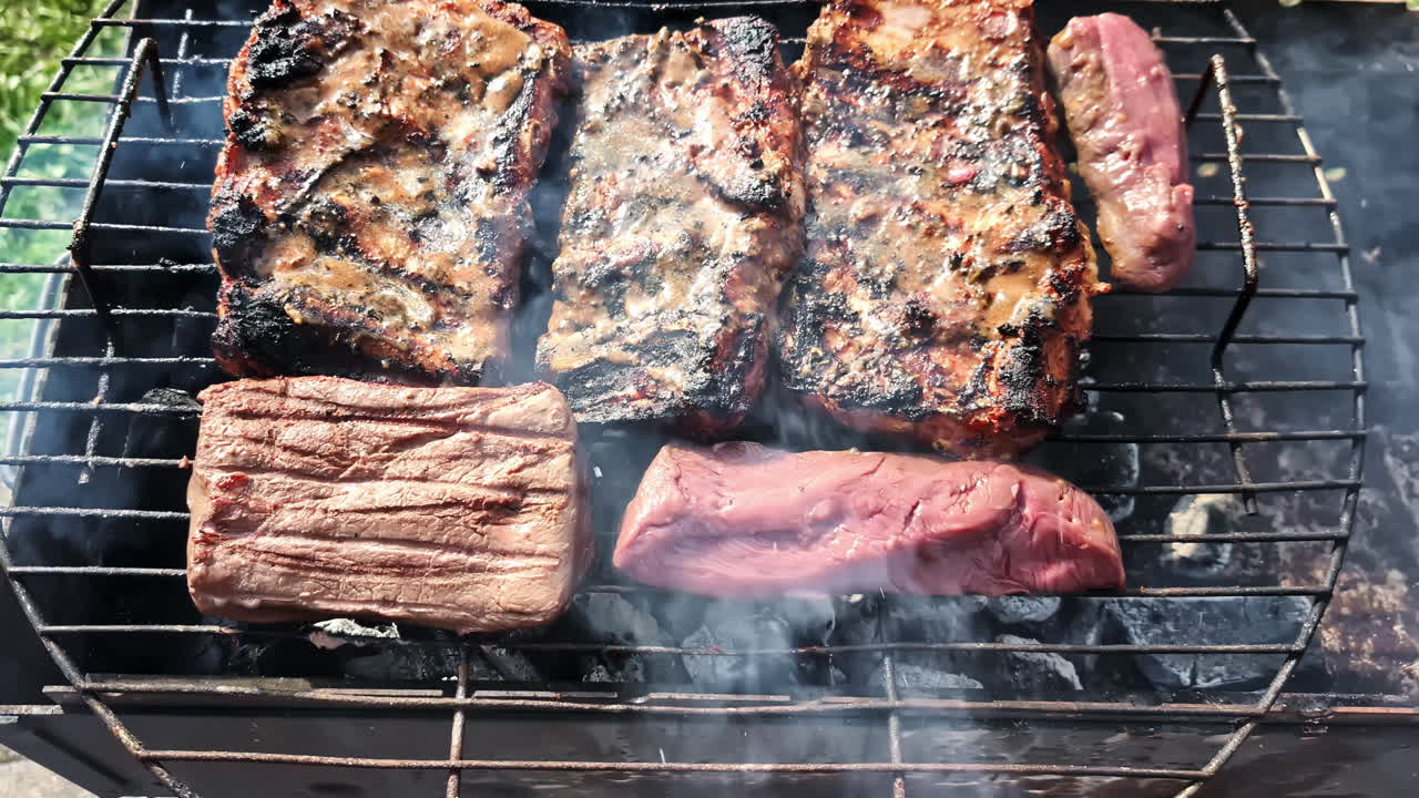 Cooking meat outdoors, camping grill POV with red steak smoking, hand twisting slice close up