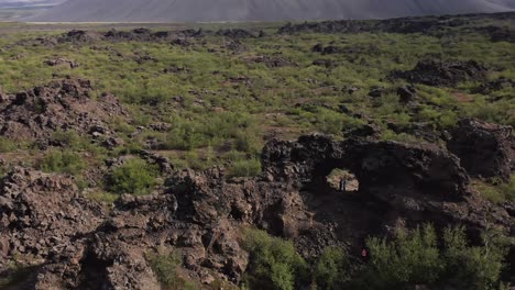 Silhouette-of-couple-in-famous-lava-cave-of-rugged-iceland-wilderness