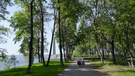 elderly couple walking in a park by the river