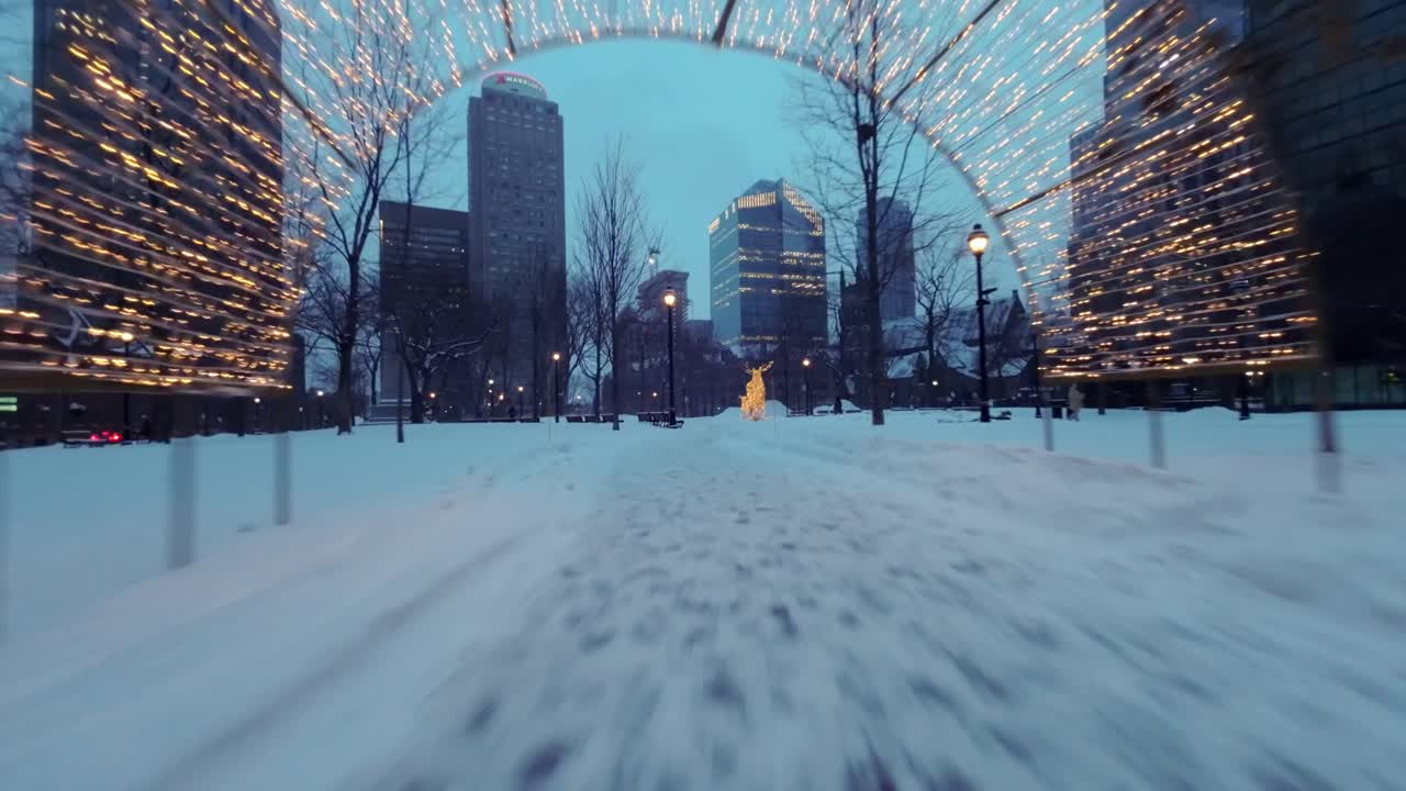Fpv drone flight through festive winter scenery in Square Dorchester, Montreal