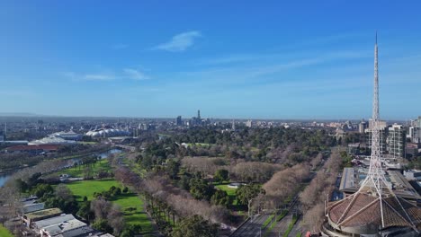 wide view over melbourne gardens and sports venues with arts centre spire in foreground