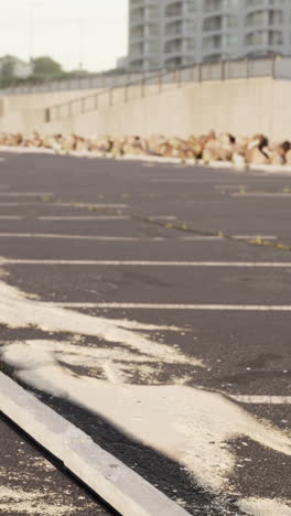 empty parking lot with concrete curb and building in background