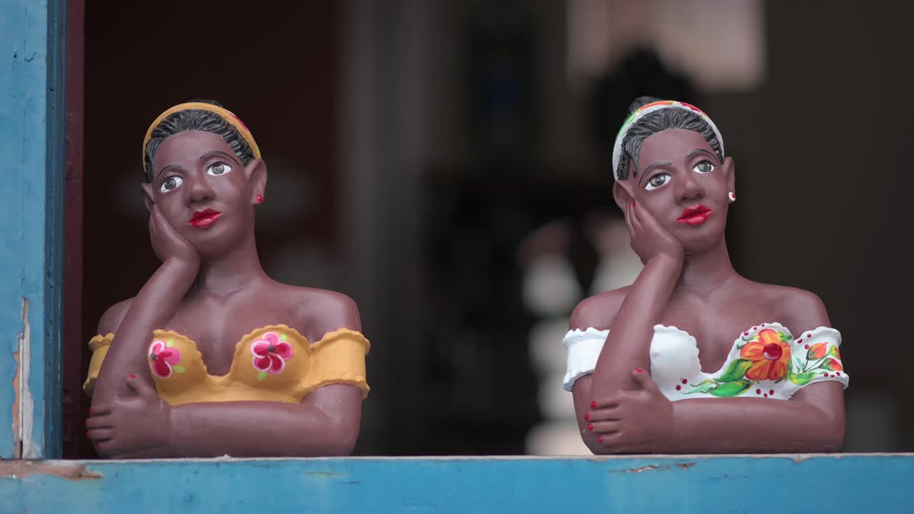 Colorful statues of women in traditional outfits in Ouro Preto, Minas Gerais, Brazil