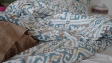 close up of a bed with patterned sheets and pillows