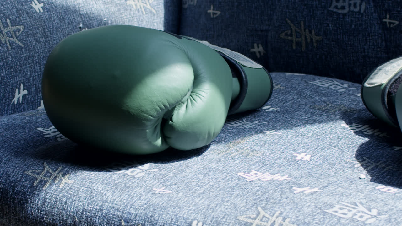 Green Boxing Gloves on a Chair