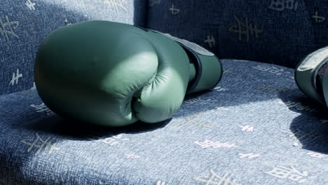 green boxing gloves on a chair