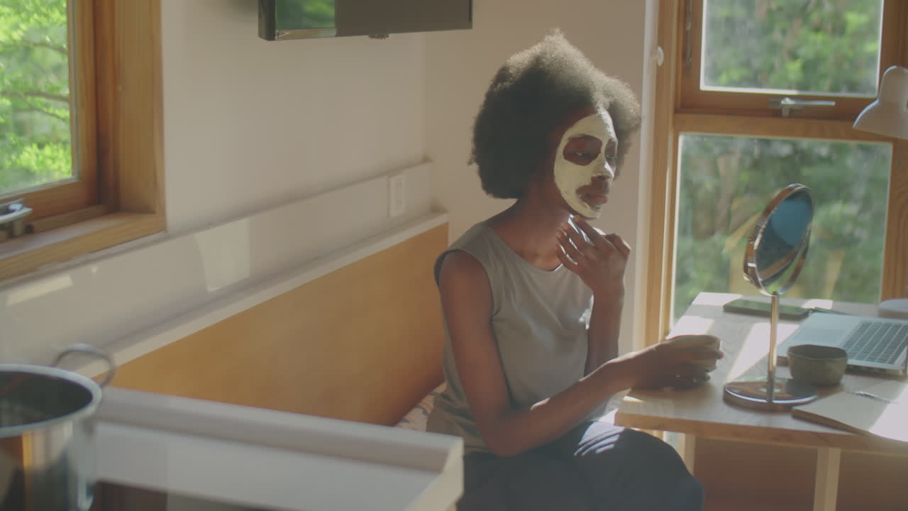 Black Woman Using Clay Mask at Home