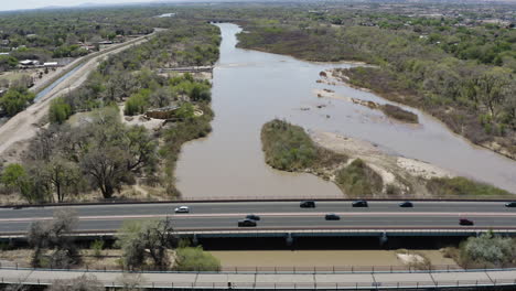 commuting traffic on highway road bridge over rio grande river - aerial