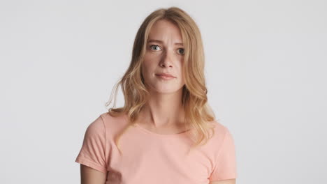 Caucasian woman waving no with the head on camera.