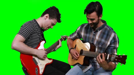 Male-musicians-playing-guitar