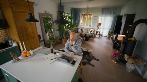 man working from home in a modern open concept kitchen and living room