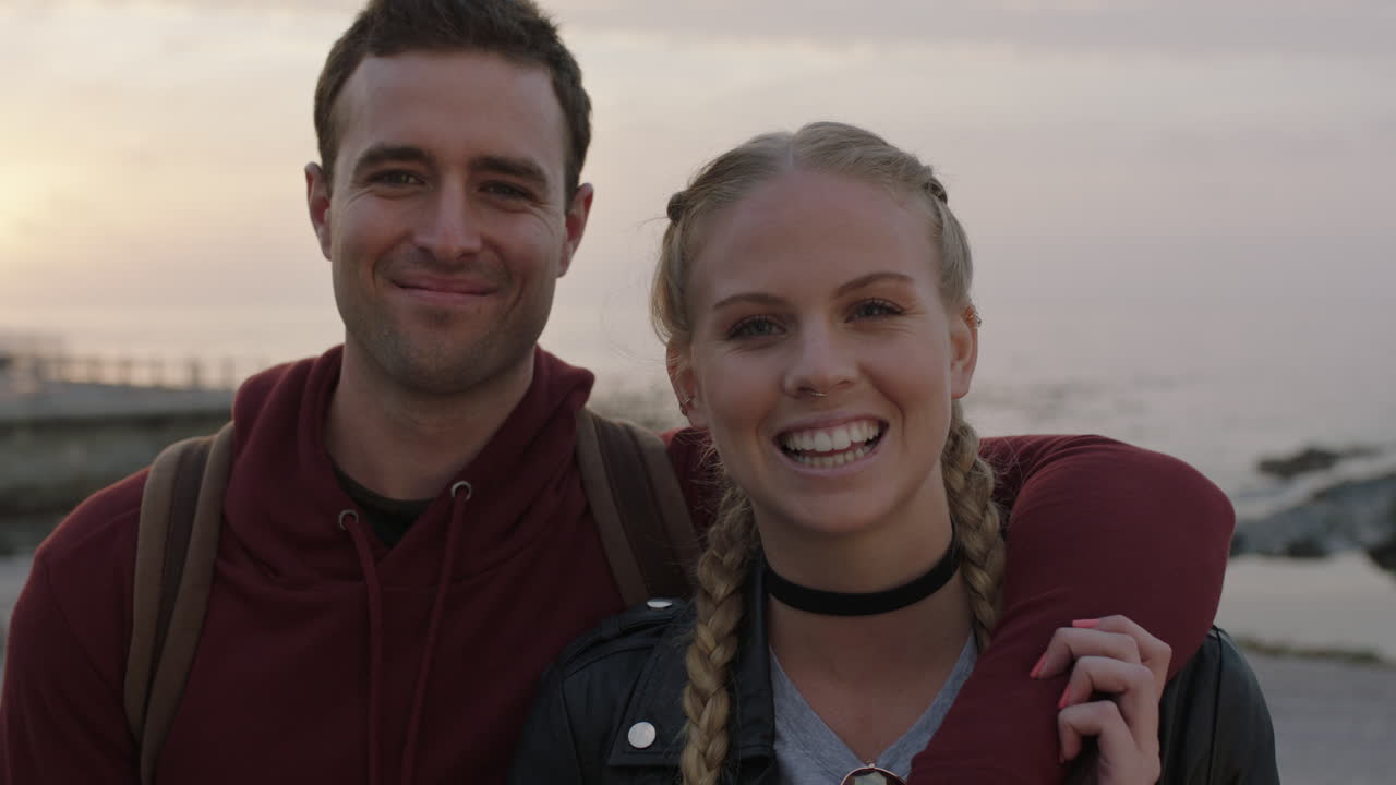 portrait of happy couple embracing man puts arm around girlfriend