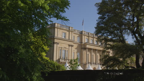 lancaster house through foliage in west end of london, united kingdom