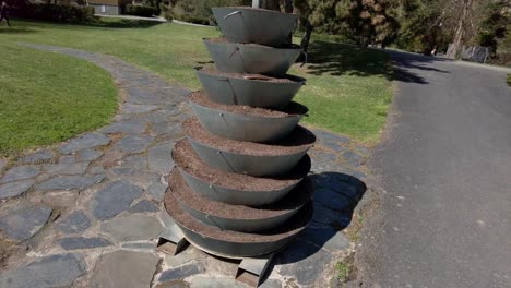 First-Person-View-Of-Tiered-Art-Sculpture-In-Green-Olomouc-City-Botanic-Garden-In-Czech-Republic